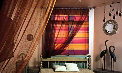 Фото: Пример использования циновки из бамбука для зонирования спальни